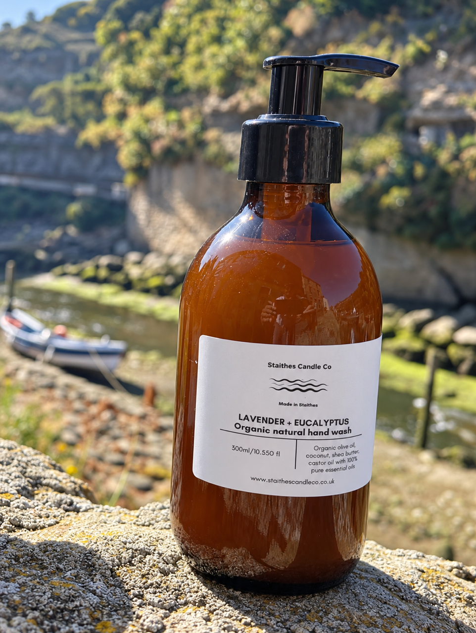An amber glass pump bottle of Staithes Candle Co Lavender + Eucalyptus organic natural hand wash.