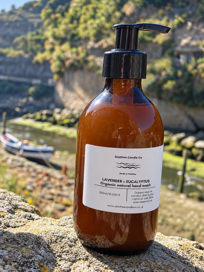 An amber glass pump bottle of Staithes Candle Co Lavender + Eucalyptus organic natural hand wash.