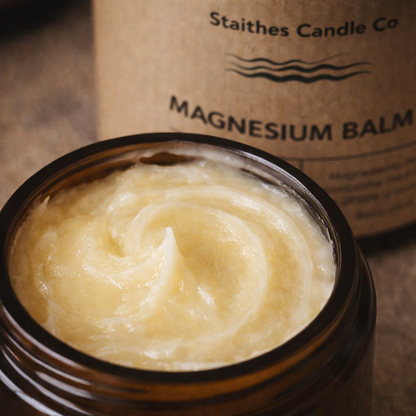 Jar of magnesium balm with Staithes Candle Co packaging in the background