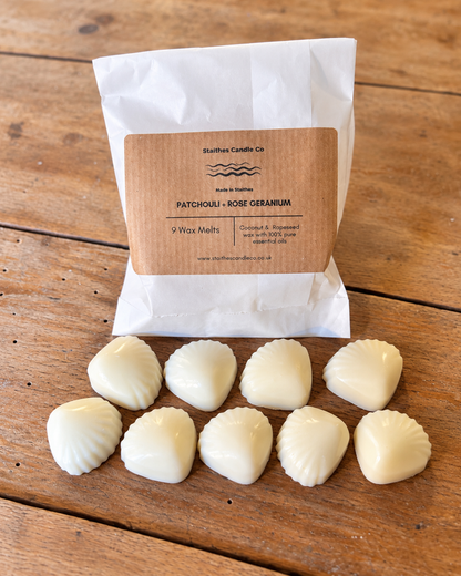 A white paper bag labeled Staithes Candle Co. PATCHOLLI - ROSE GERANIUM' with nine small white wax melts