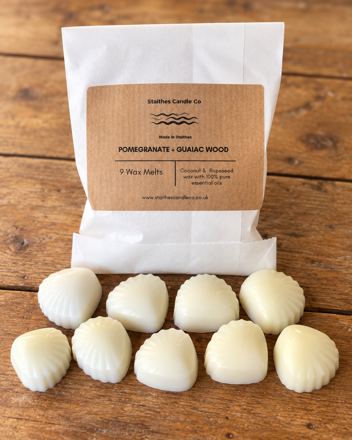 A white paper bag of Stalthes Candle Co. Pomegranate + Guaiac Wood scented wax melts 
